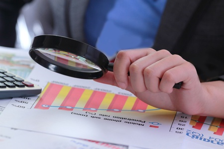 Business woman using a Magnifying Glass