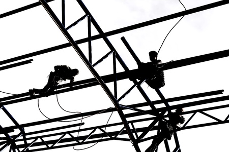 Silhouette of construction workers on white backgroundの写真素材