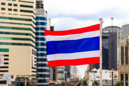 National flag of Thailand with a city background の写真素材