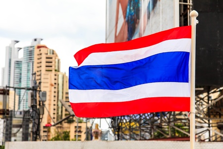 National flag of Thailand with a city background の写真素材