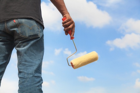 Man holding a paint rollerの写真素材