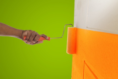 Orange color painting wall with rollerの写真素材