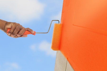 Orange color painting wall with rollerの写真素材