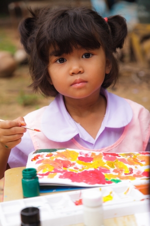 Asian students in countryside thailand. painting in outdoorsの写真素材