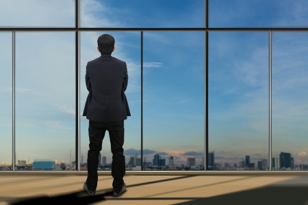 Businessman looking through window の写真素材