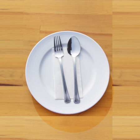 Fork and spoon and plate on table