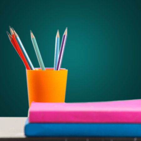 Pencils and book on table の写真素材
