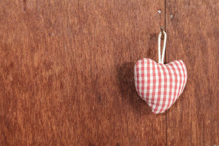Fabric heart on the wallの写真素材
