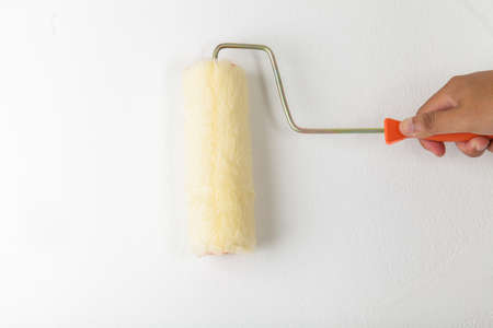 Hand holding paint rollerの写真素材