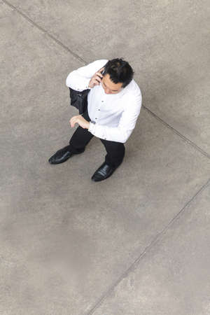 Top view of businessman using smart phoneの写真素材