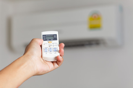 Hand turning on air conditioning 