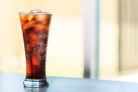 Cola drink with ice in glass