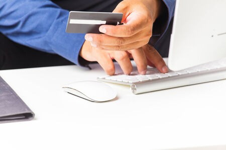Businessman typing and making online payment with credit card