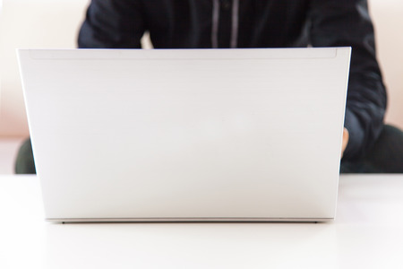 male hands typing on laptop keyboardの写真素材