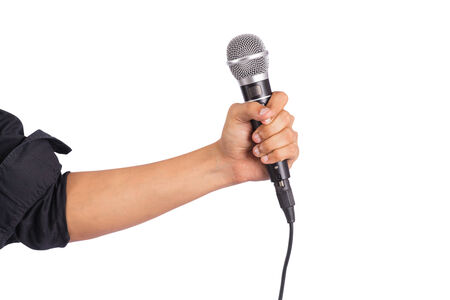 Male hand holding microphone on white backgroundの写真素材