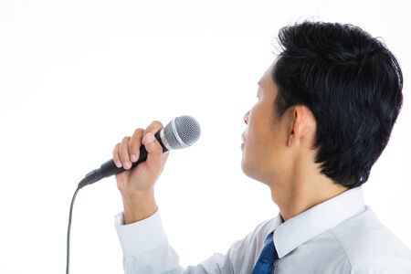 Portrait of a man holding a microphone conducting a business interview or press conferenceの写真素材