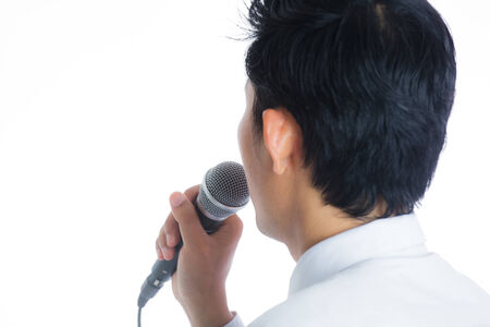 Portrait of a man holding a microphone conducting a business interview or press conferenceの写真素材
