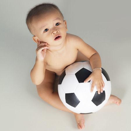 Portrait of a baby with footballの写真素材