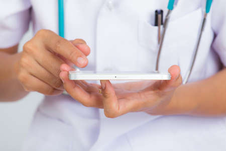 Female doctor using mobile phoneの写真素材