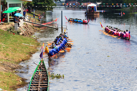 PATHUM THANI, THAILAND - OCT 25 : Unidentified rowers in native Thai long boats compete during King