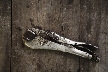 Old pliers on wood backgroundの写真素材
