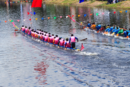 PATHUM THANI, THAILAND - OCT 25 : Unidentified rowers in native Thai long boats compete during...