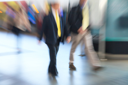 Business people walking in the city in motion blurの写真素材