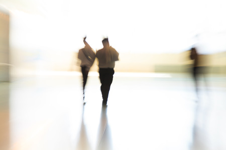 Business people rushing in the lobby. motion blurの写真素材