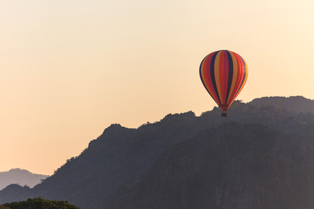 Hot air balloon over mountain, Vang Vieng, Laosの写真素材