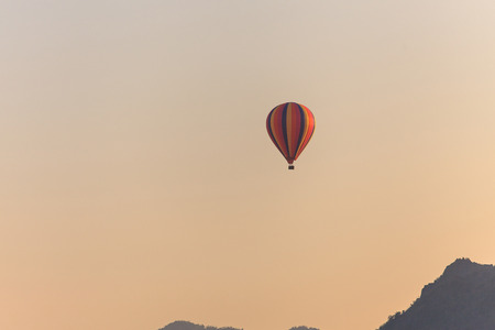 Hot air balloon over mountain, Vang Vieng, Laosの写真素材
