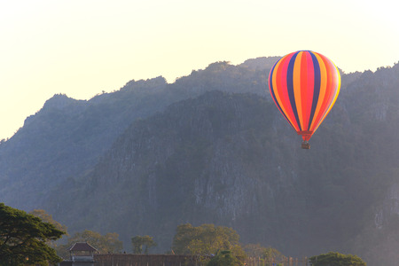 Hot air balloon over mountain, Vang Vieng, Laosの写真素材