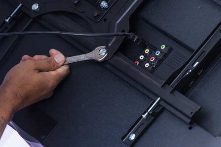 Installing mount TV on the wall at home or office