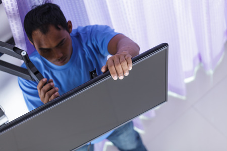 Installing mount TV on the wall at home or officeの写真素材