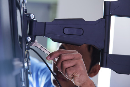 Installing mount TV on the wall at home or office
