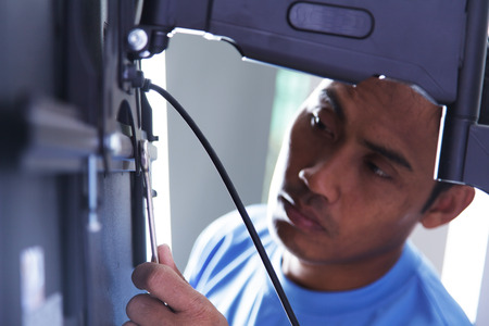 Installing mount TV on the wall at home or officeの写真素材