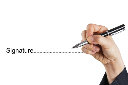 Fingers holding pen writing signatureの写真素材