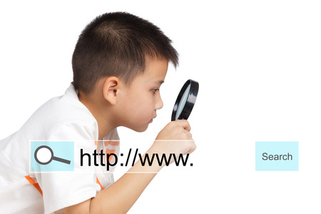 Boy holding a magnifying glass, Internet conceptの写真素材