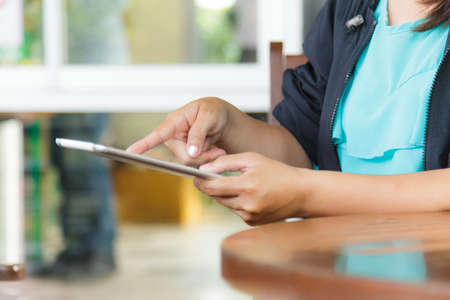 Cropped view of women using a digital tablet in outdoor