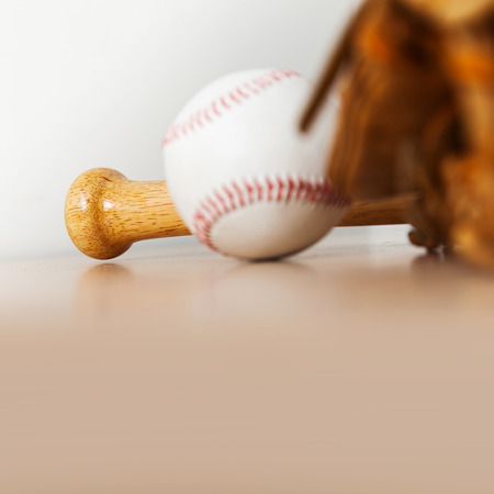 Baseball bat with ball and baseball glove on wood backgroundの写真素材