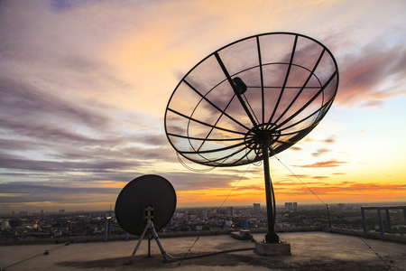 Satellite dish sky in twilight in the cityの写真素材