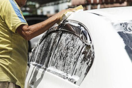 Washing a car at car wash serviceの写真素材