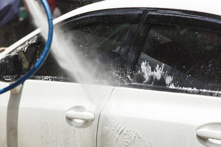 Washing a car at car wash serviceの写真素材