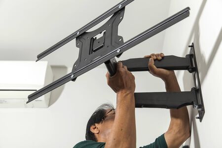 Installing mount TV on the wall at homeの写真素材