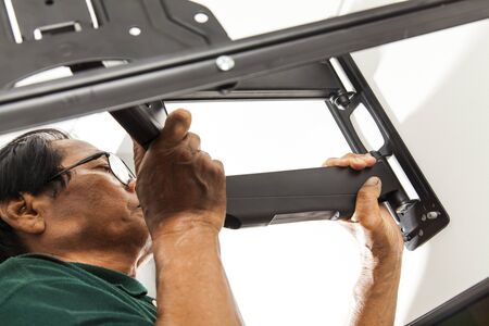 Installing mount TV on the wall at homeの写真素材