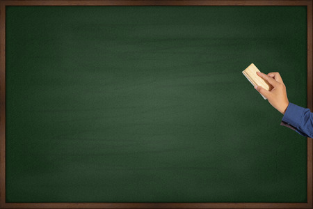 Hand cleaning the chalkboardの写真素材
