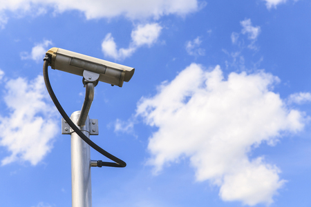 Security camera on blue sky background