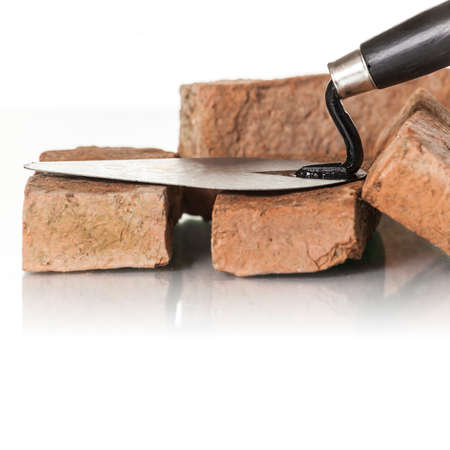 Bricks and trowel on white background