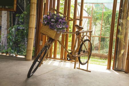 flower in basket of vintage wooden bicycleの写真素材