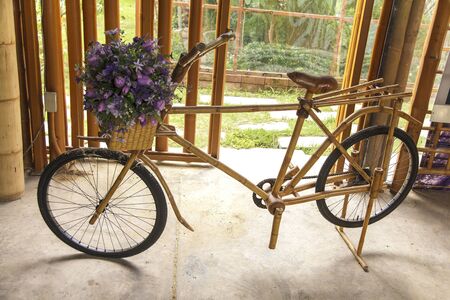 flower in basket of vintage wooden bicycleの写真素材