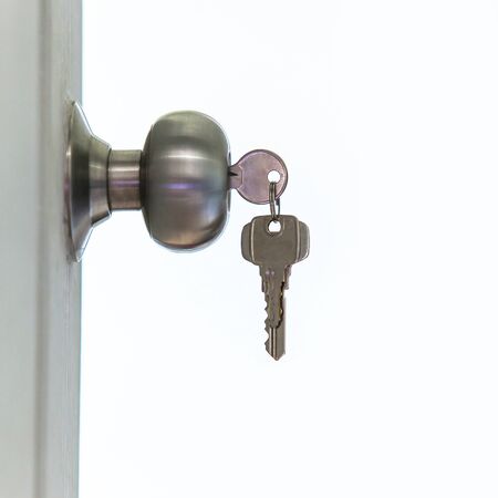 Open door with keys, key in keyholeの写真素材